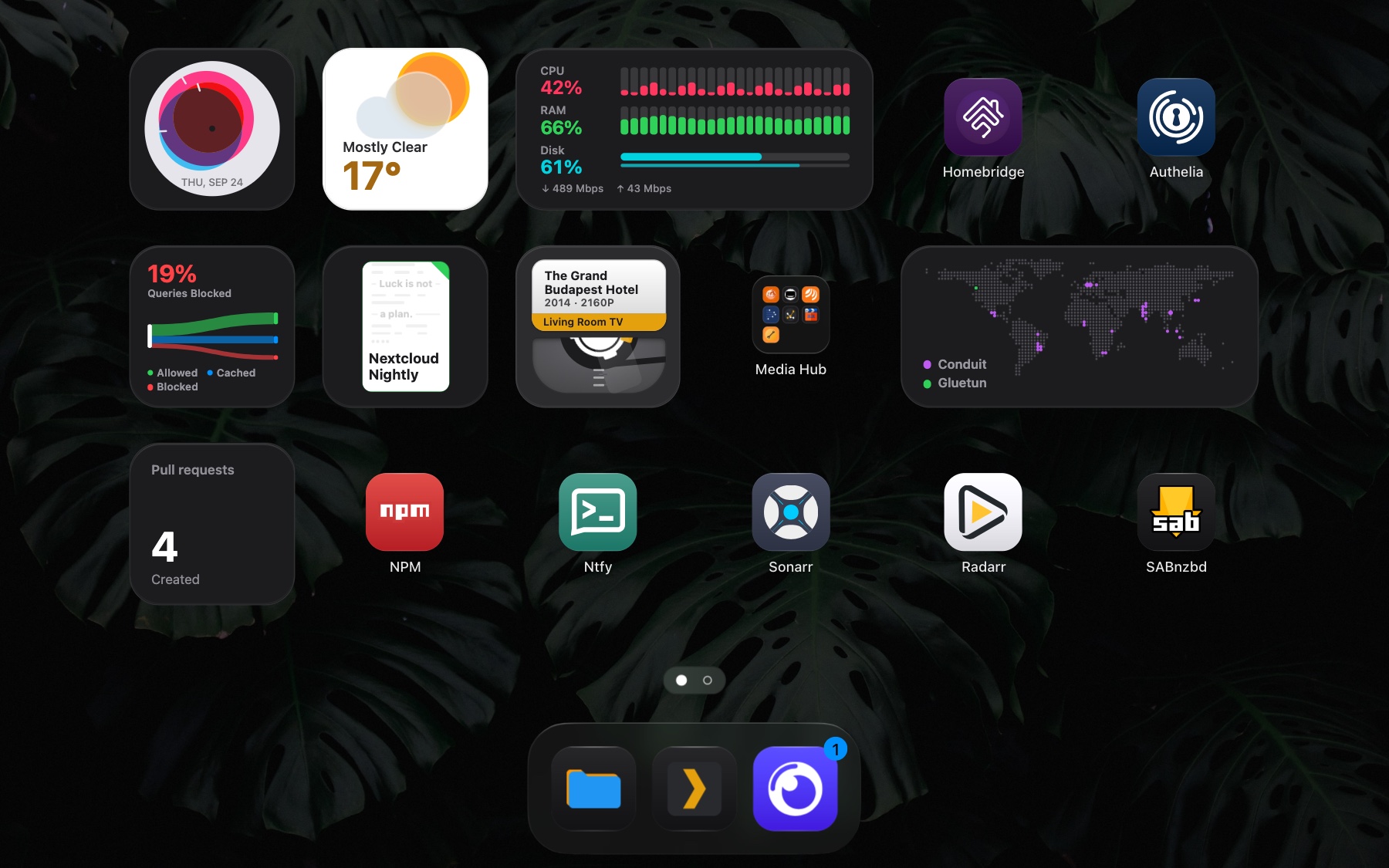 The Stackyard dashboard, with widgets, app tiles, two folders and the dock.